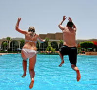 guy and girl playing in pool 